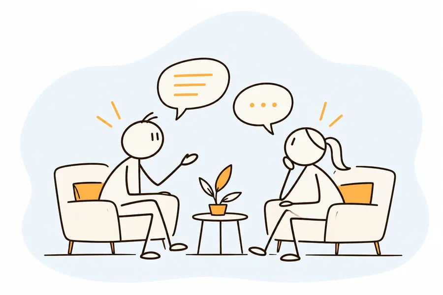 A coach and client talking in armchairs